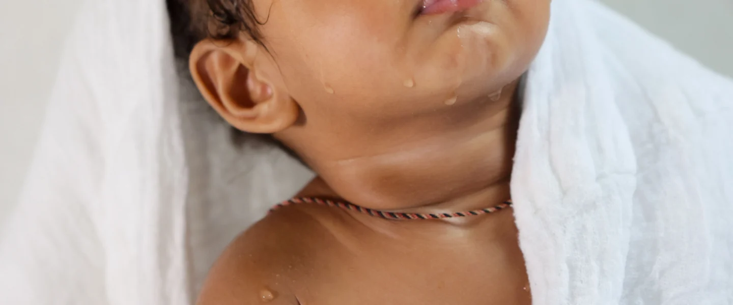 How often should you bathe a newborn: baby wrapped in a towel after bath time