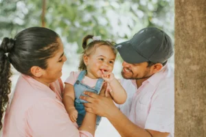 Baby sun protection: parents with a baby outdoors in a sunny park
