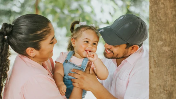 Baby sun protection: parents with a baby outdoors in a sunny park