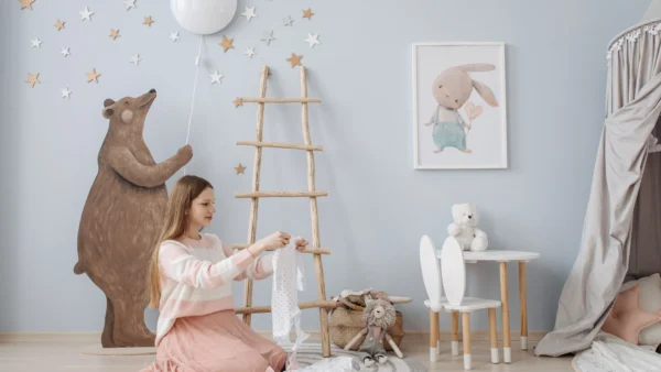 Newborn clothing checklist: parent organizing baby clothes in a nursery